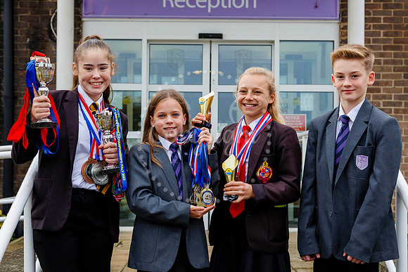 Harleston Sancroft Academy pupils with some of the medals and aw