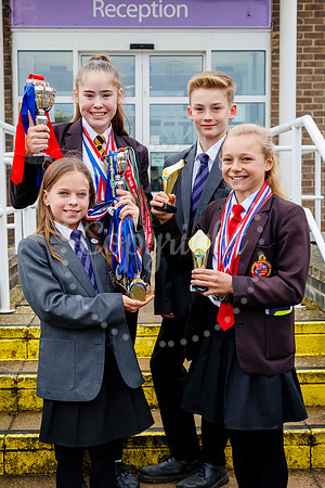 Harleston Sancroft Academy pupils with some of the medals and aw