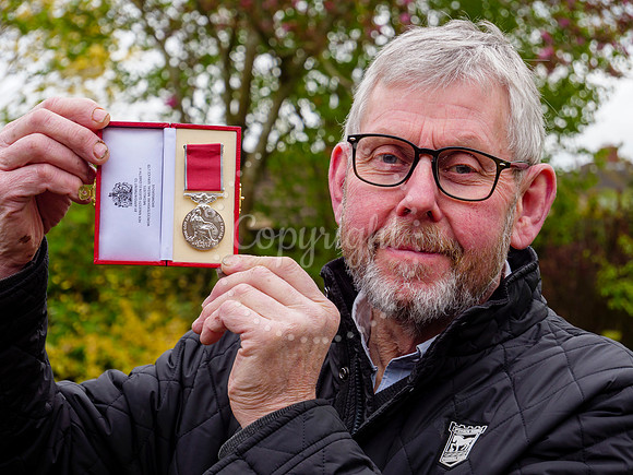 Framlingham shop owner Bill Bulstrode has been awarded a BEM med